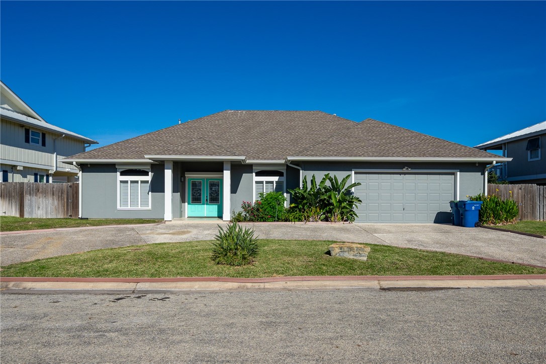 a front view of a house with a garden and yard