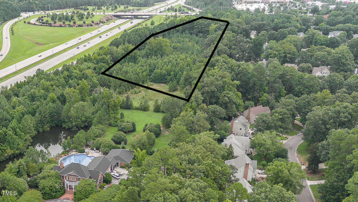 an aerial view of a house with a yard and outdoor seating