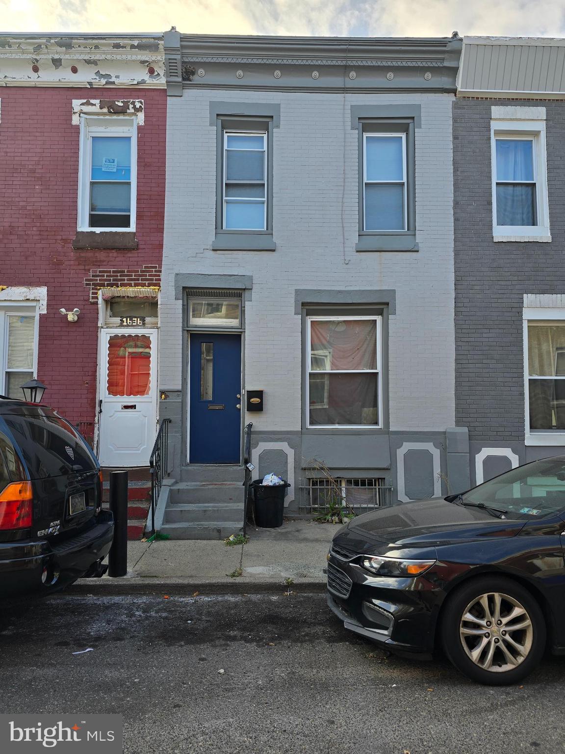 a car parked in front of a brick house