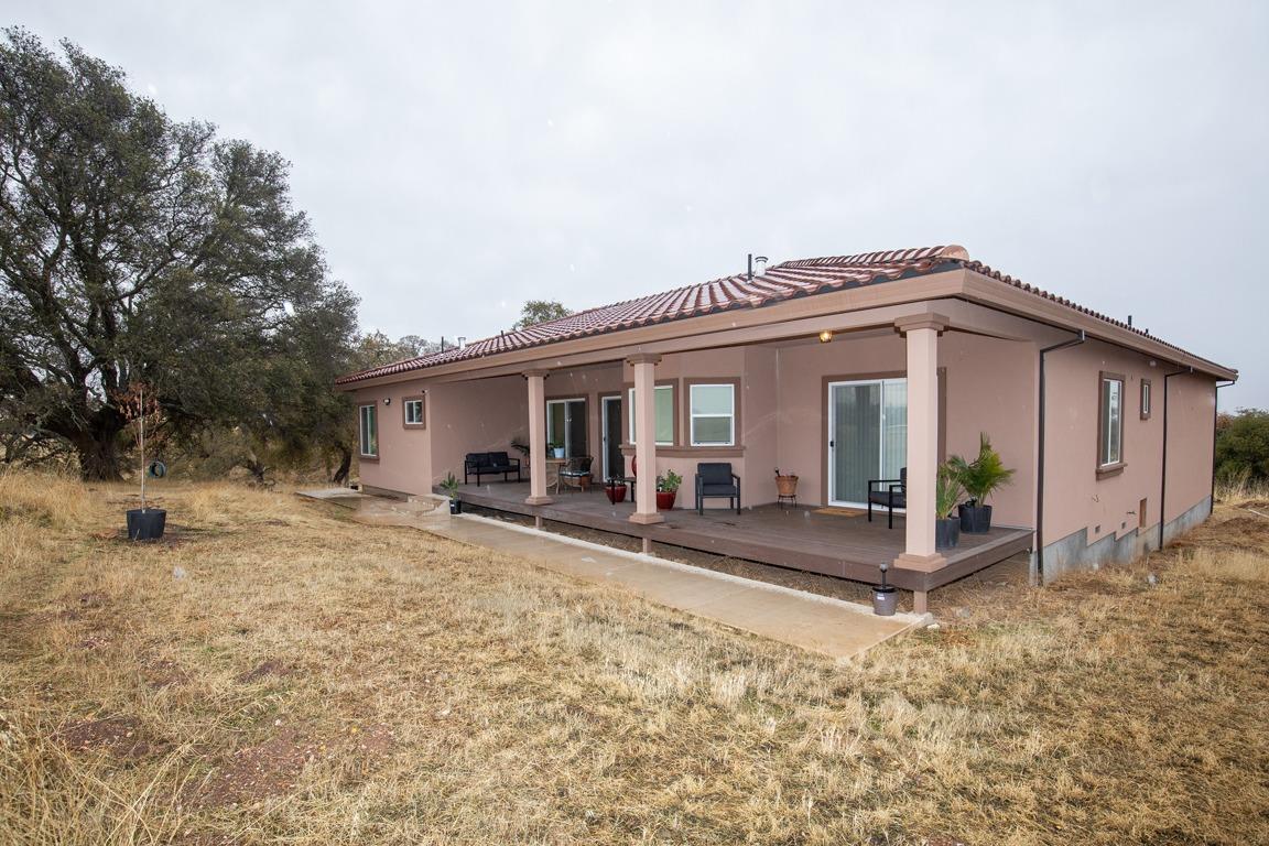 a view of a house with backyard and sitting area