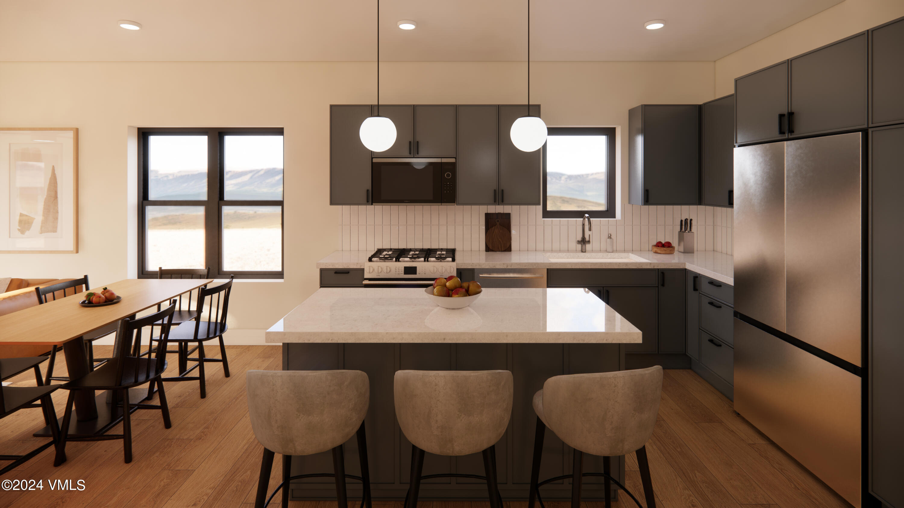 a kitchen with stainless steel appliances a dining table chairs microwave and sink