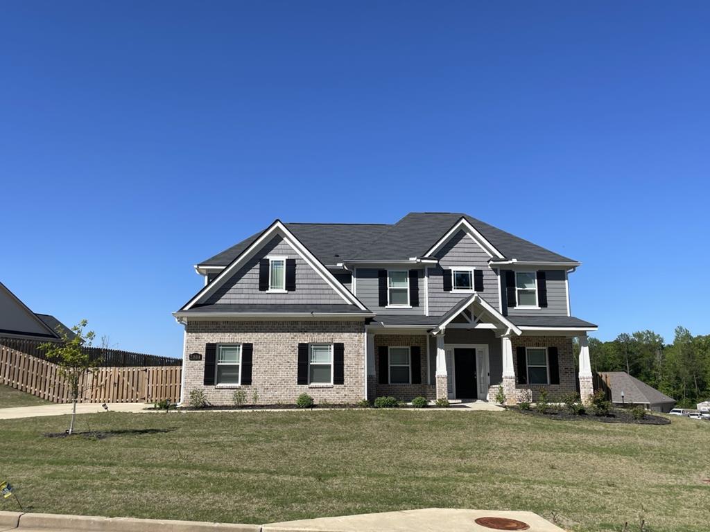 a front view of a house with a garden