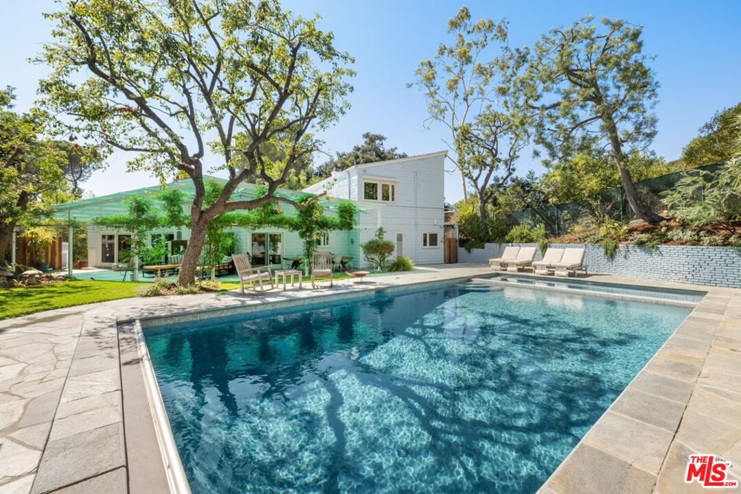 a view of swimming pool with outdoor seating and yard