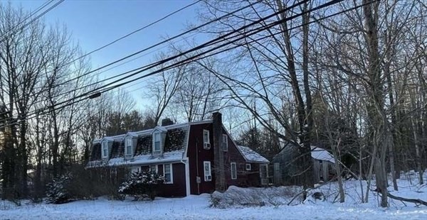 a front view of a house with trees