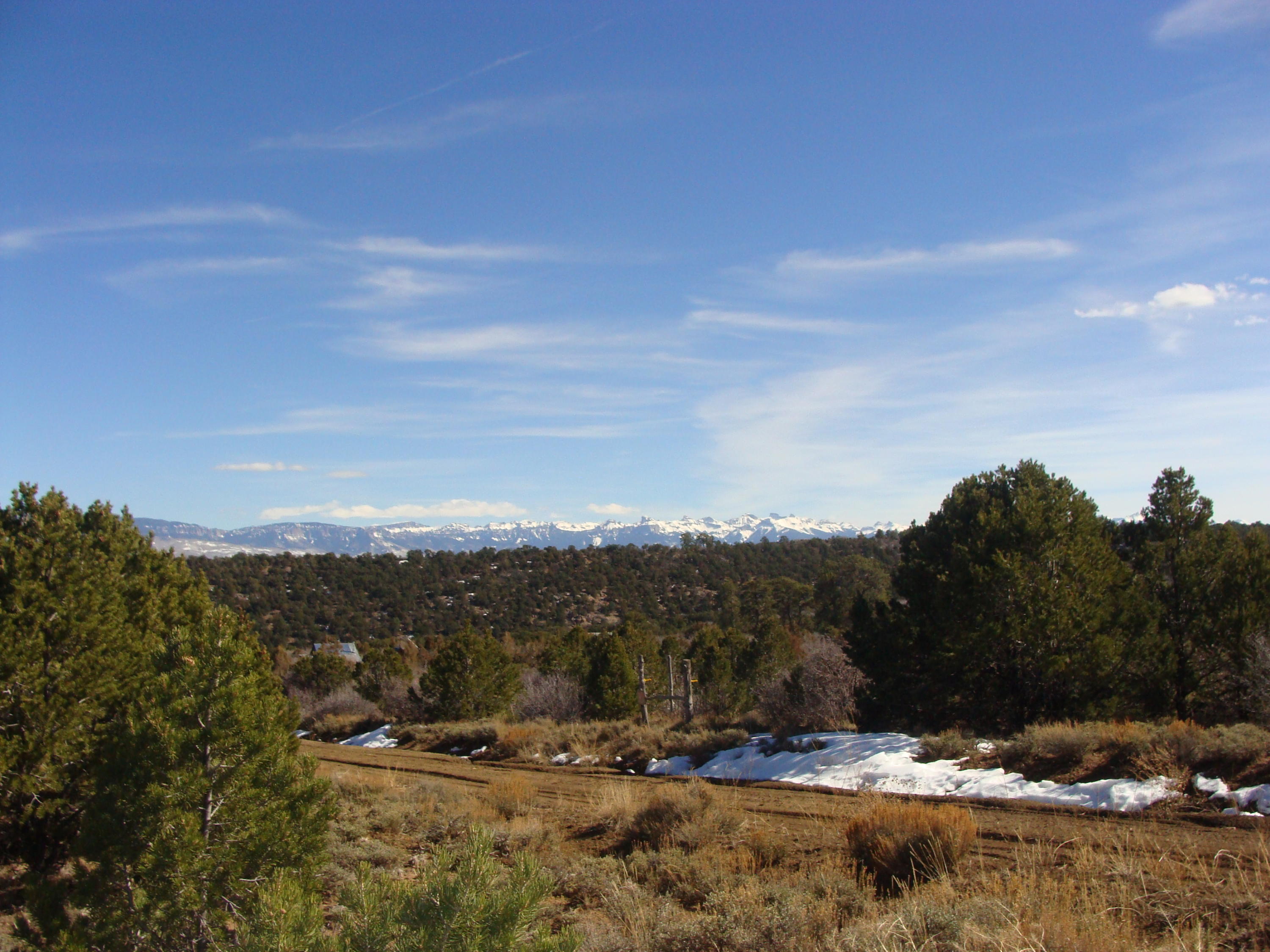 a view of top of a city with mountains in the background