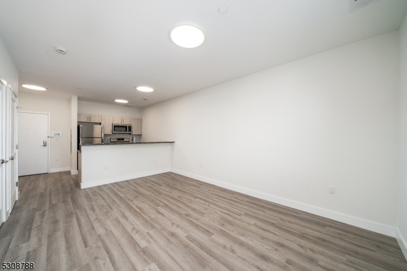 a view of kitchen cabinet and wooden floor