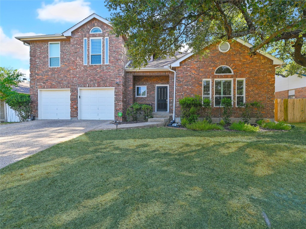 a front view of a house with a yard and garage