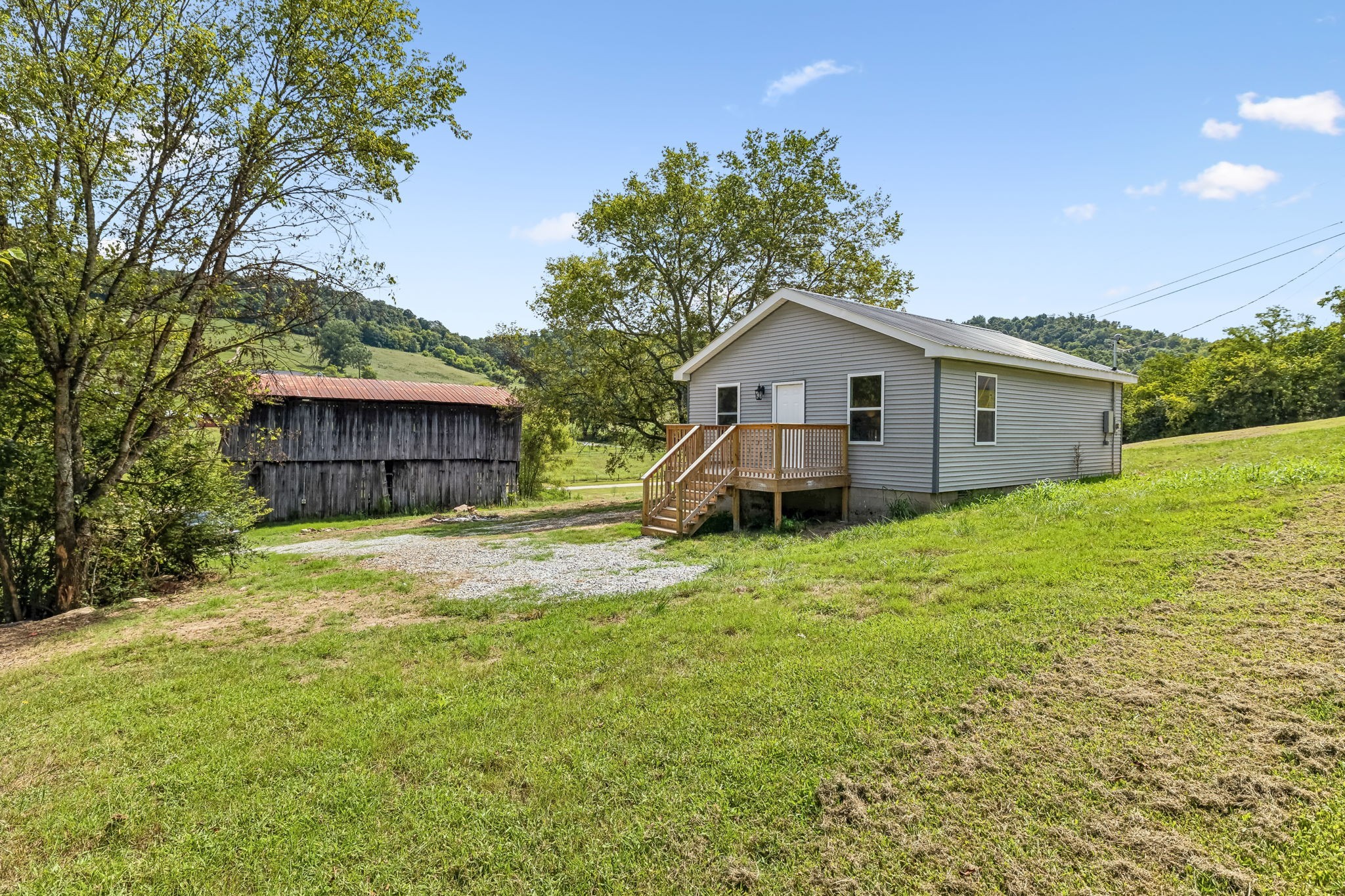 a view of a house with a yard and fence