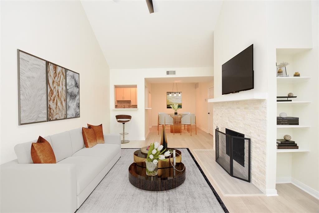 a living room with furniture a fireplace and a flat screen tv