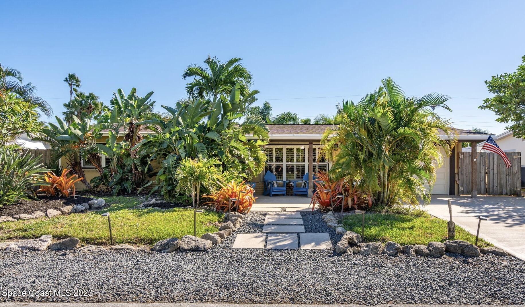 a view of a house with a yard and sitting area