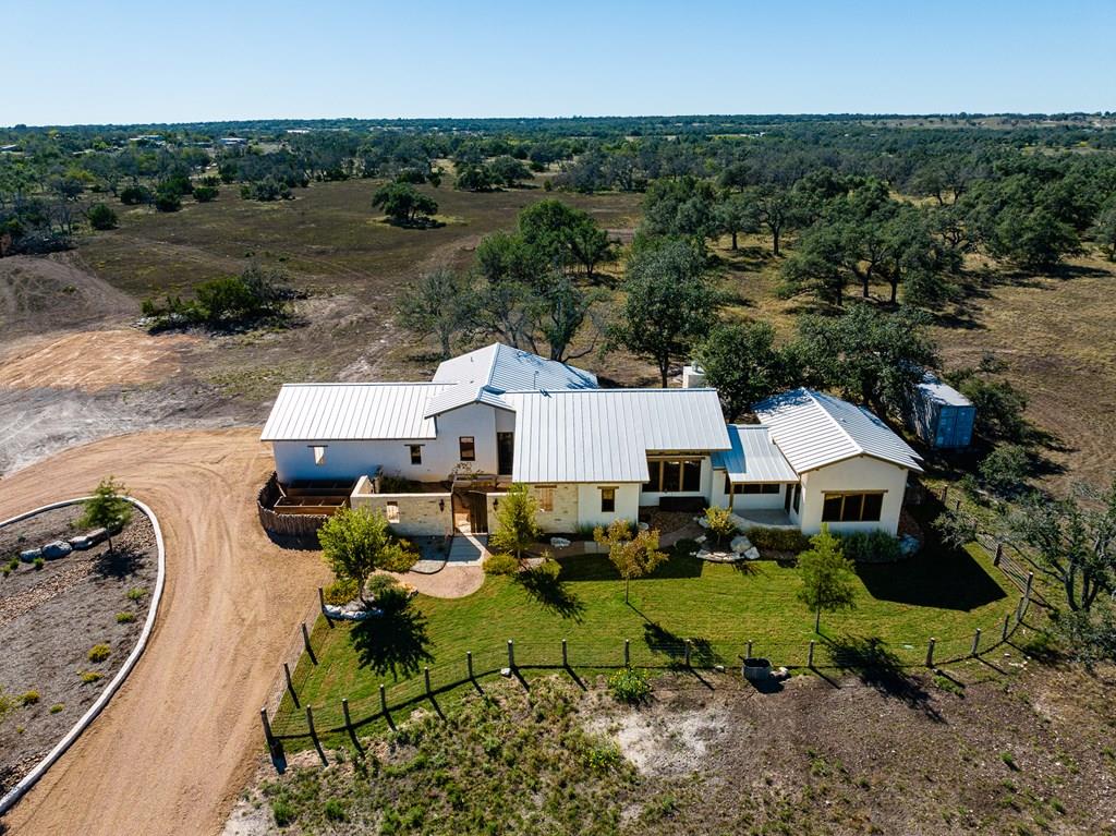 an aerial view of a house with yard swimming pool and outdoor seating