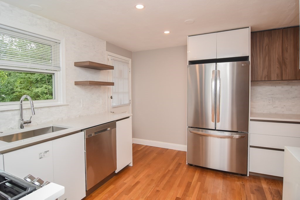 a kitchen with stainless steel appliances a refrigerator and a sink