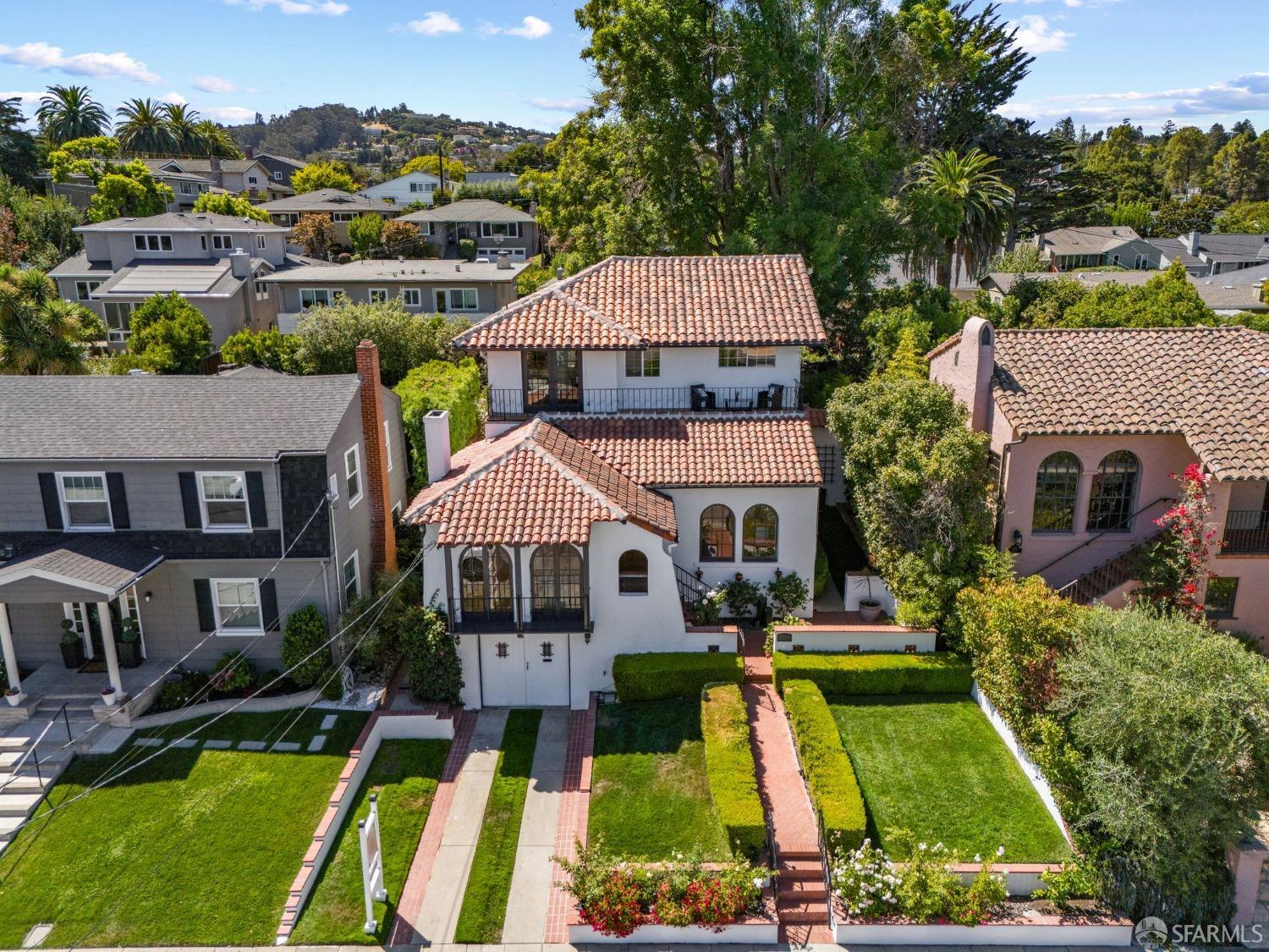 an aerial view of a house with swimming pool and a yard