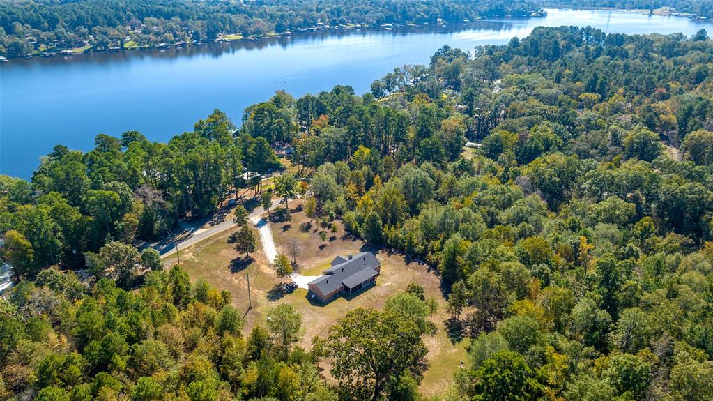 an aerial view of residential house with outdoor space and lake view