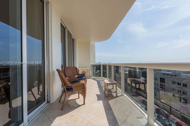 a view of a balcony with chairs