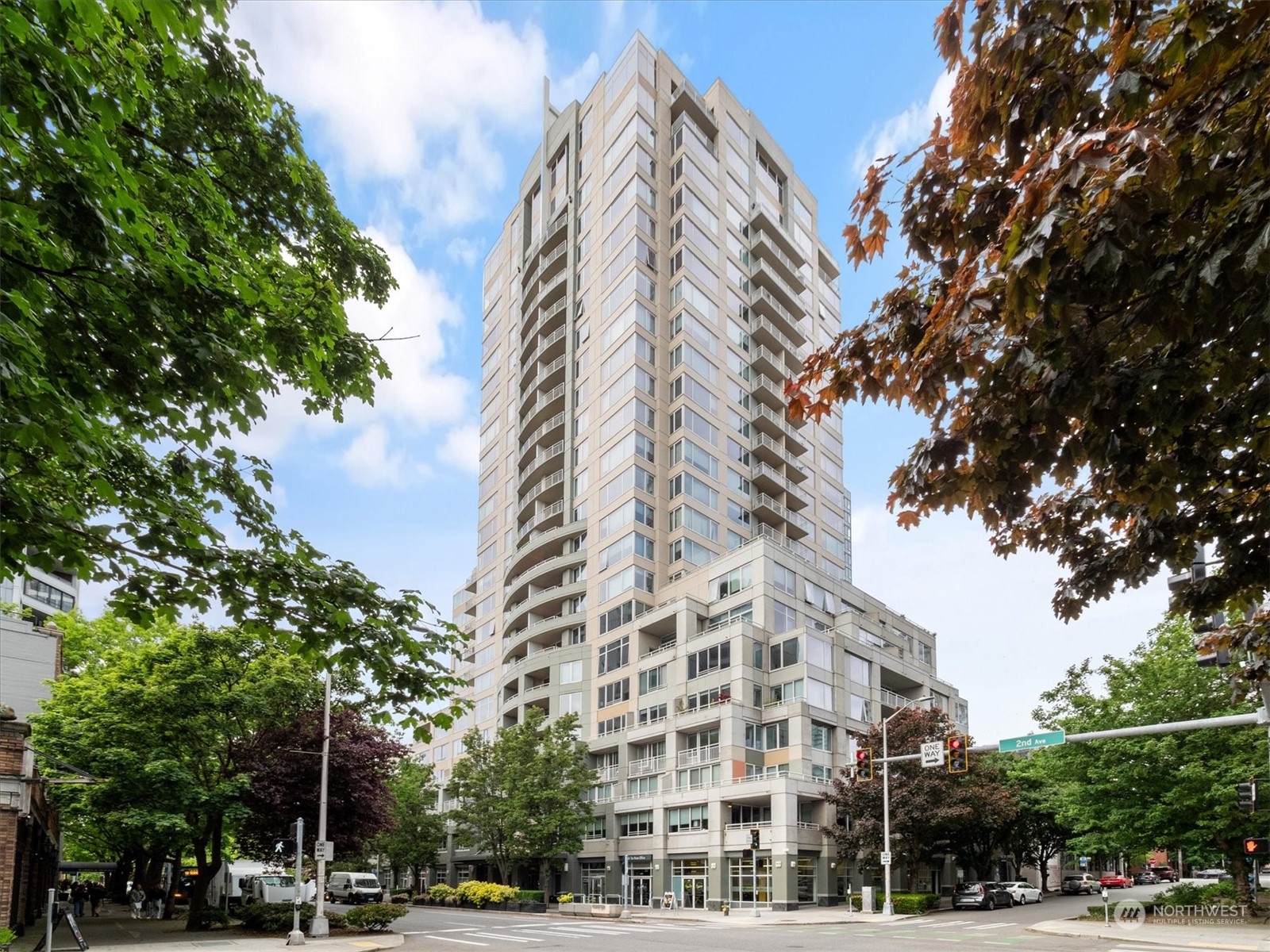 a view of a tall building next to a road