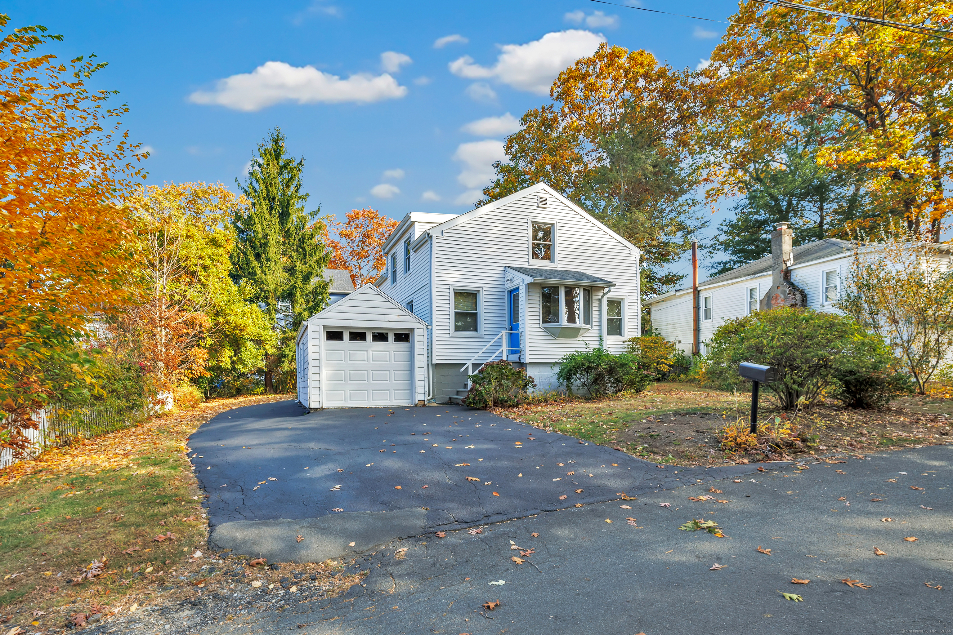 a front view of a house with a yard and a garage