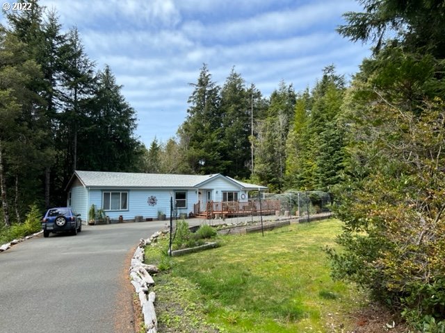 a house with green field in front of it