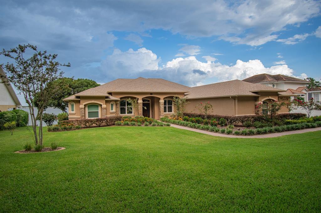 a front view of a house with a garden