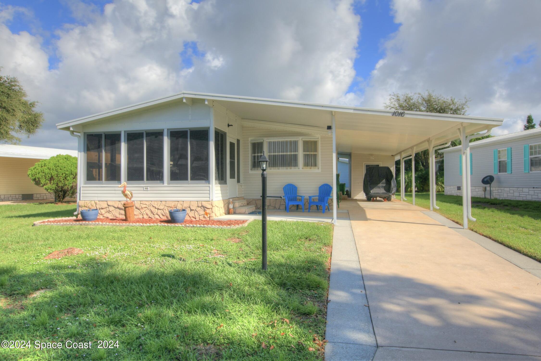 a view of a house with backyard porch and sitting area