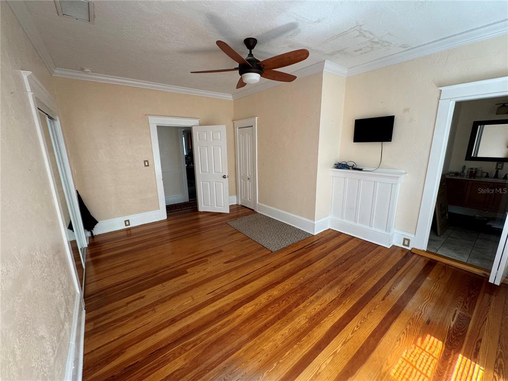 a view of a livingroom with a hardwood floor and a ceiling fan