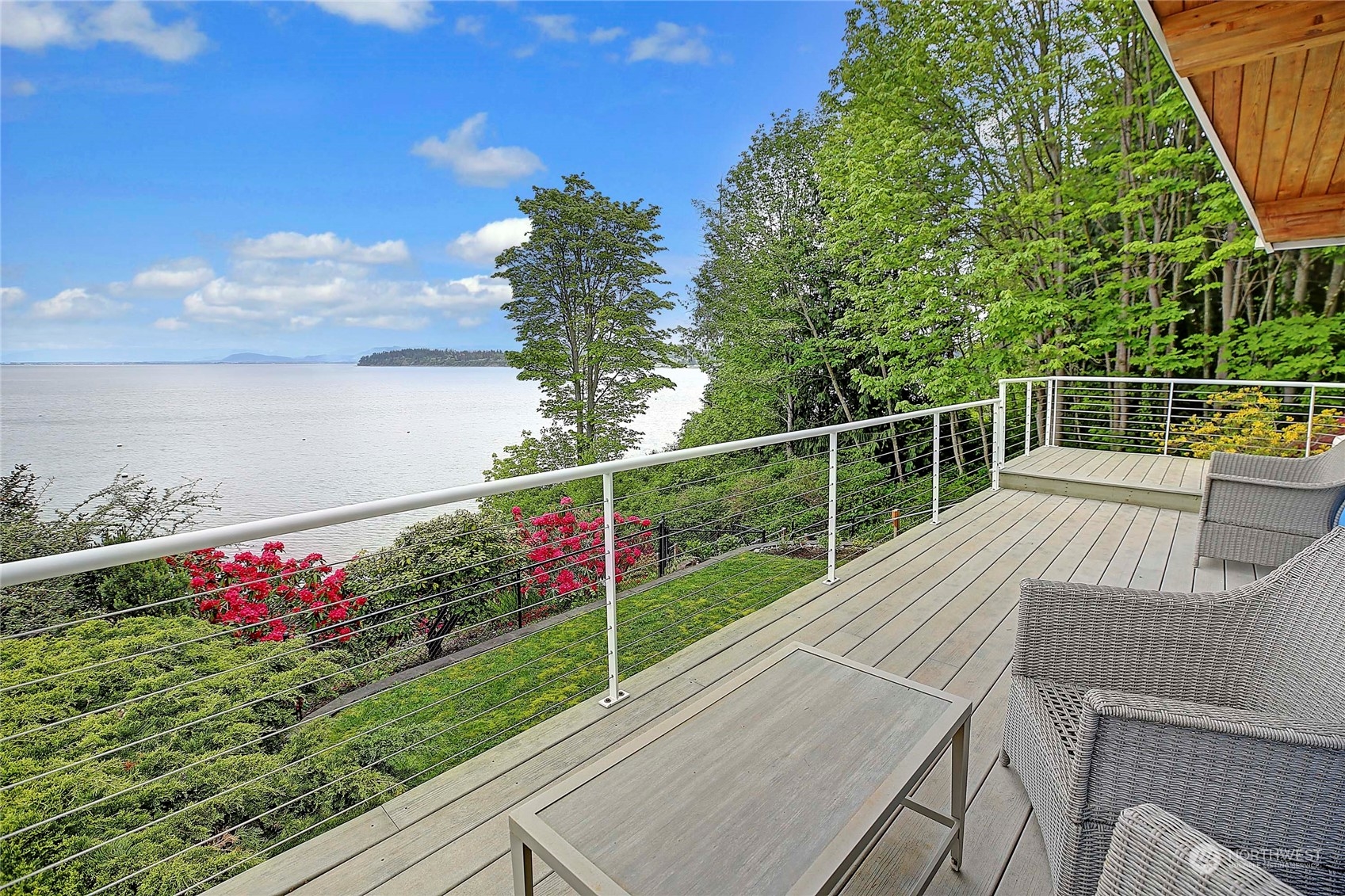 a view of a chairs and table on the wooden deck