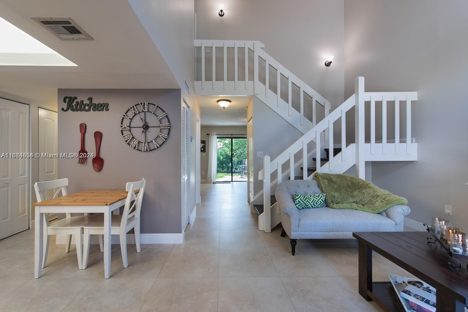 a living room with furniture and stairs