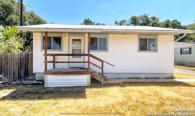 a view of a house with a wooden deck