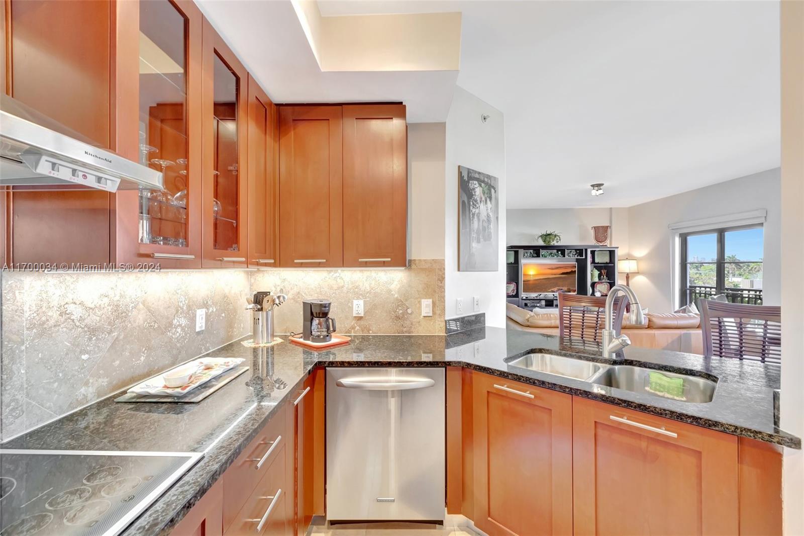 a kitchen with granite countertop a sink and a stove top oven