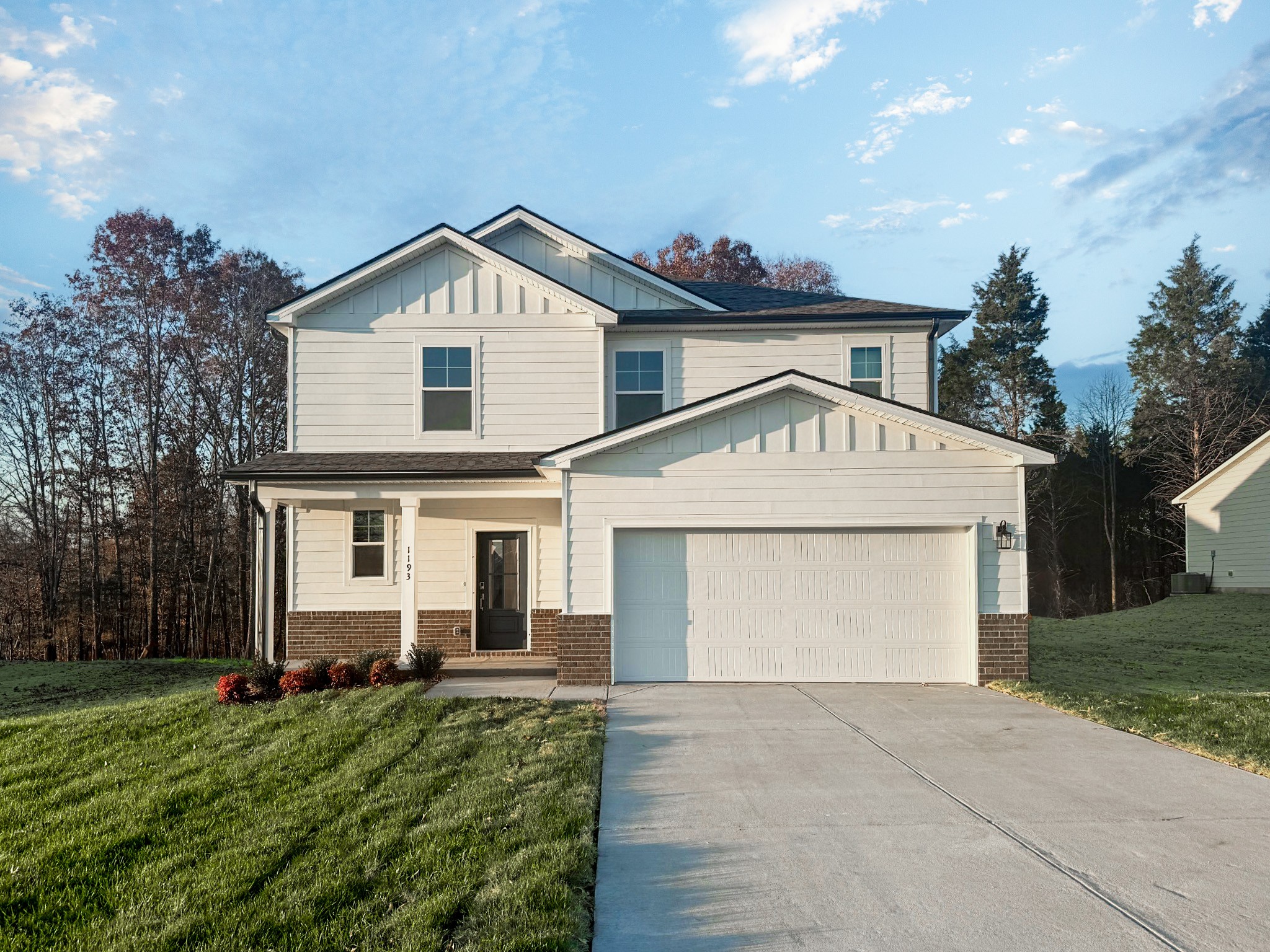 a view of a house with a yard and garage