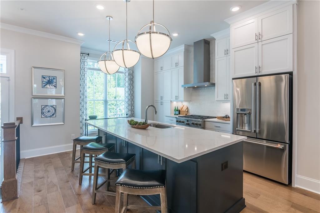 a kitchen with a table chairs refrigerator and microwave