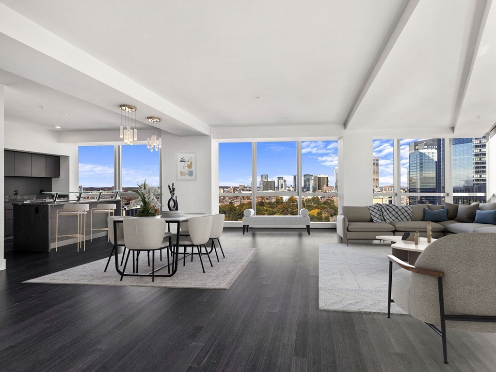 a living room with lots of furniture and kitchen view