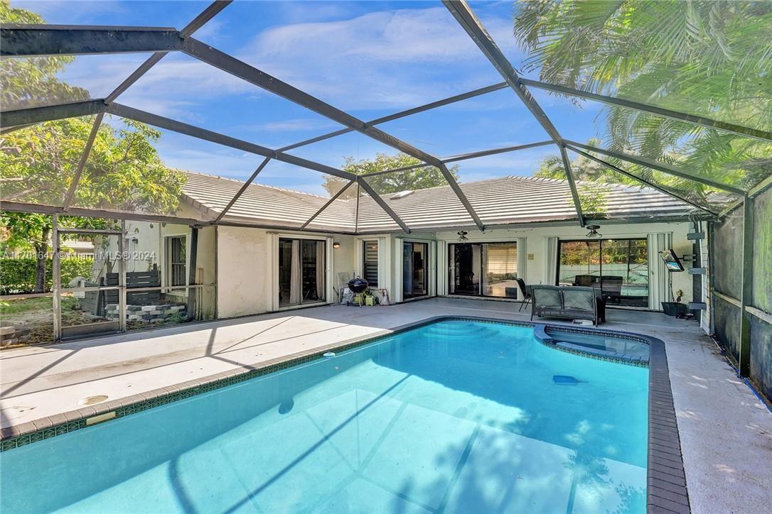 a swimming pool with outdoor seating yard and patio