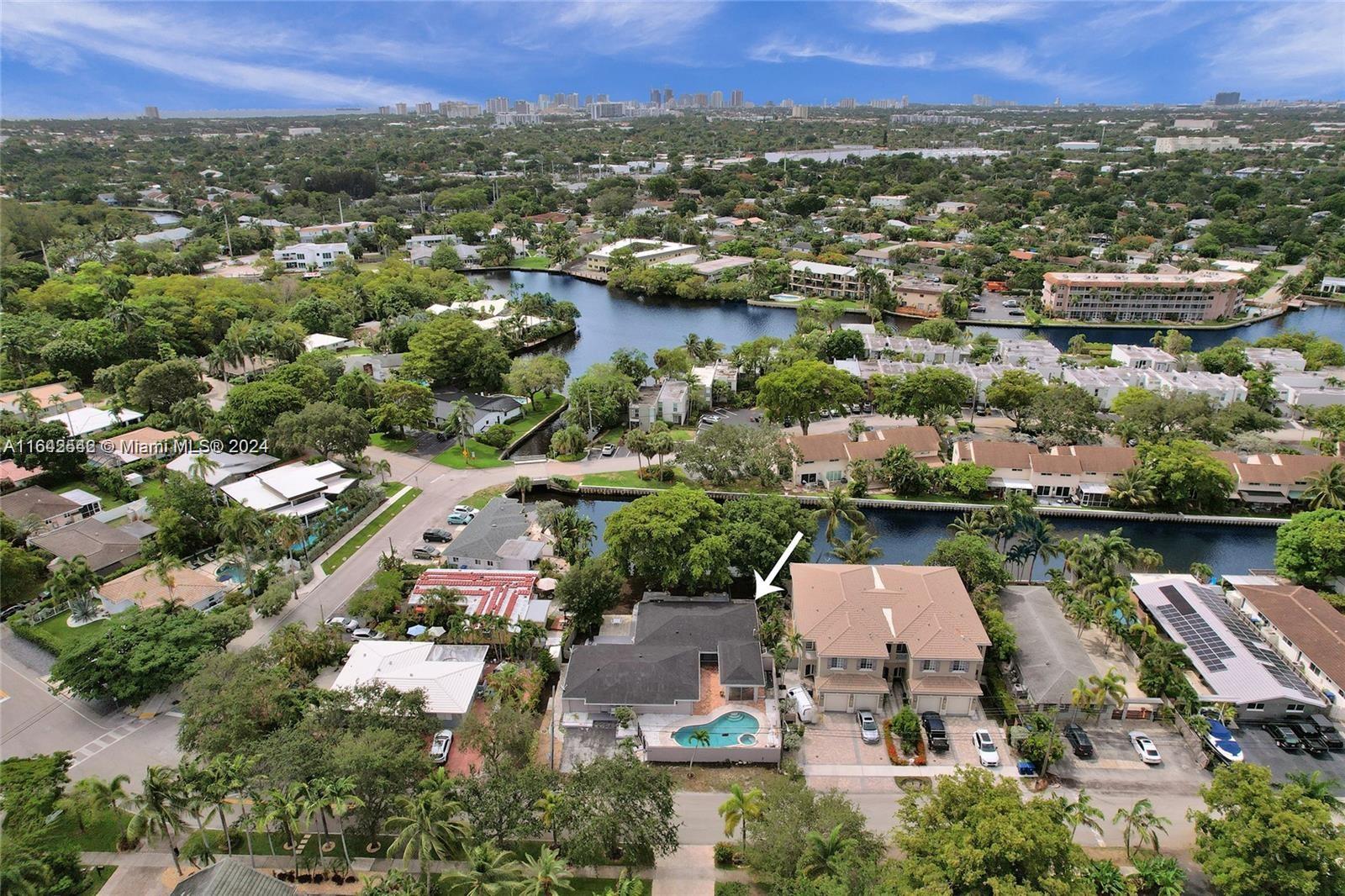 an aerial view of a city with lots of residential buildings lake and ocean view