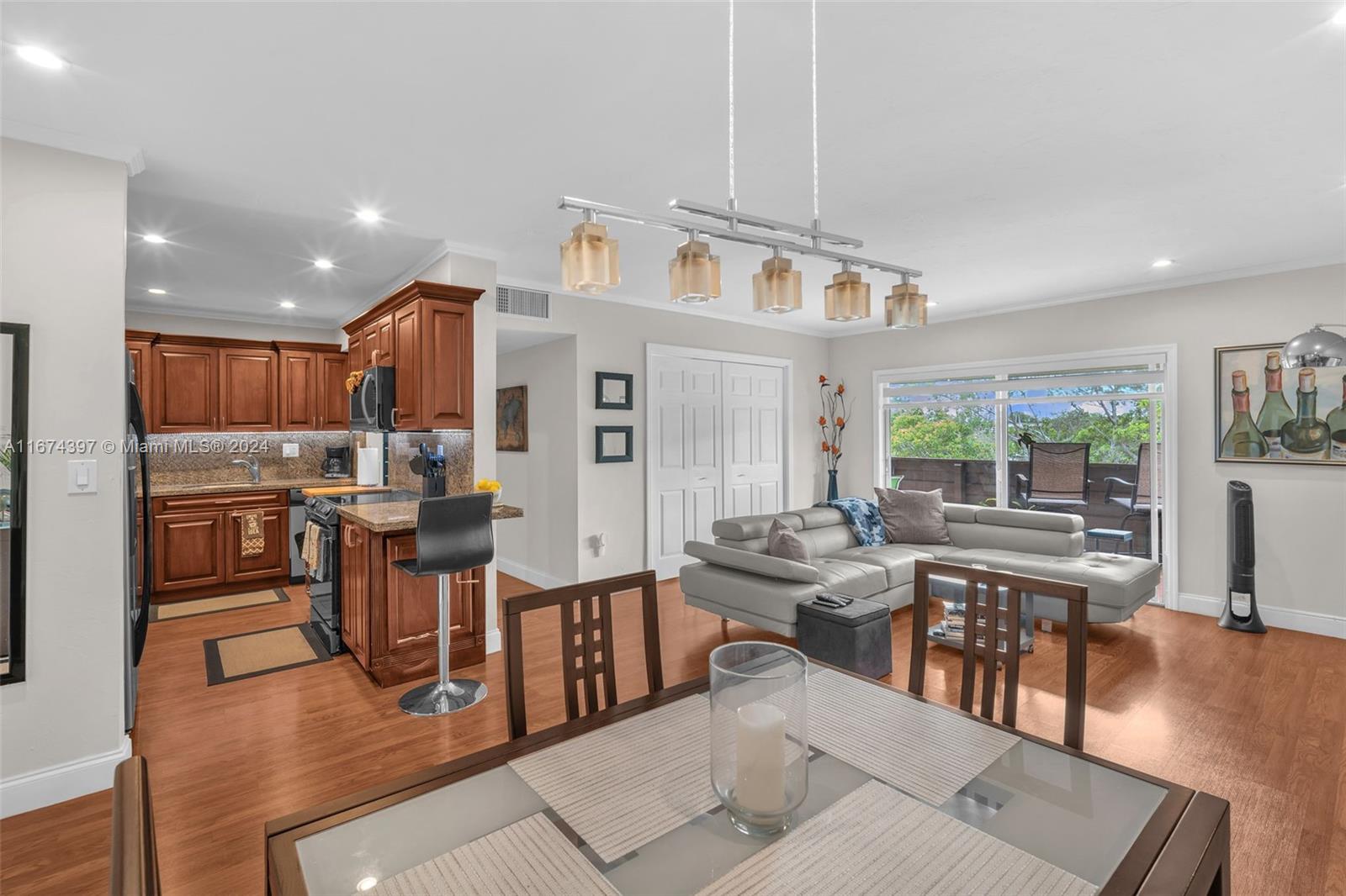 a living room with lots of furniture and kitchen view