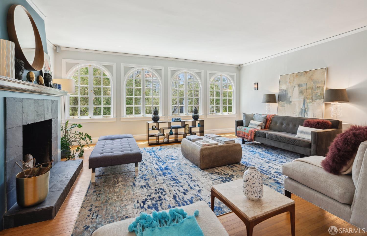 a living room with furniture fireplace and a large window