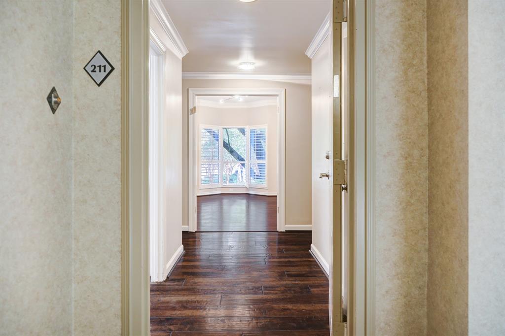 a view of hallway with wooden floor