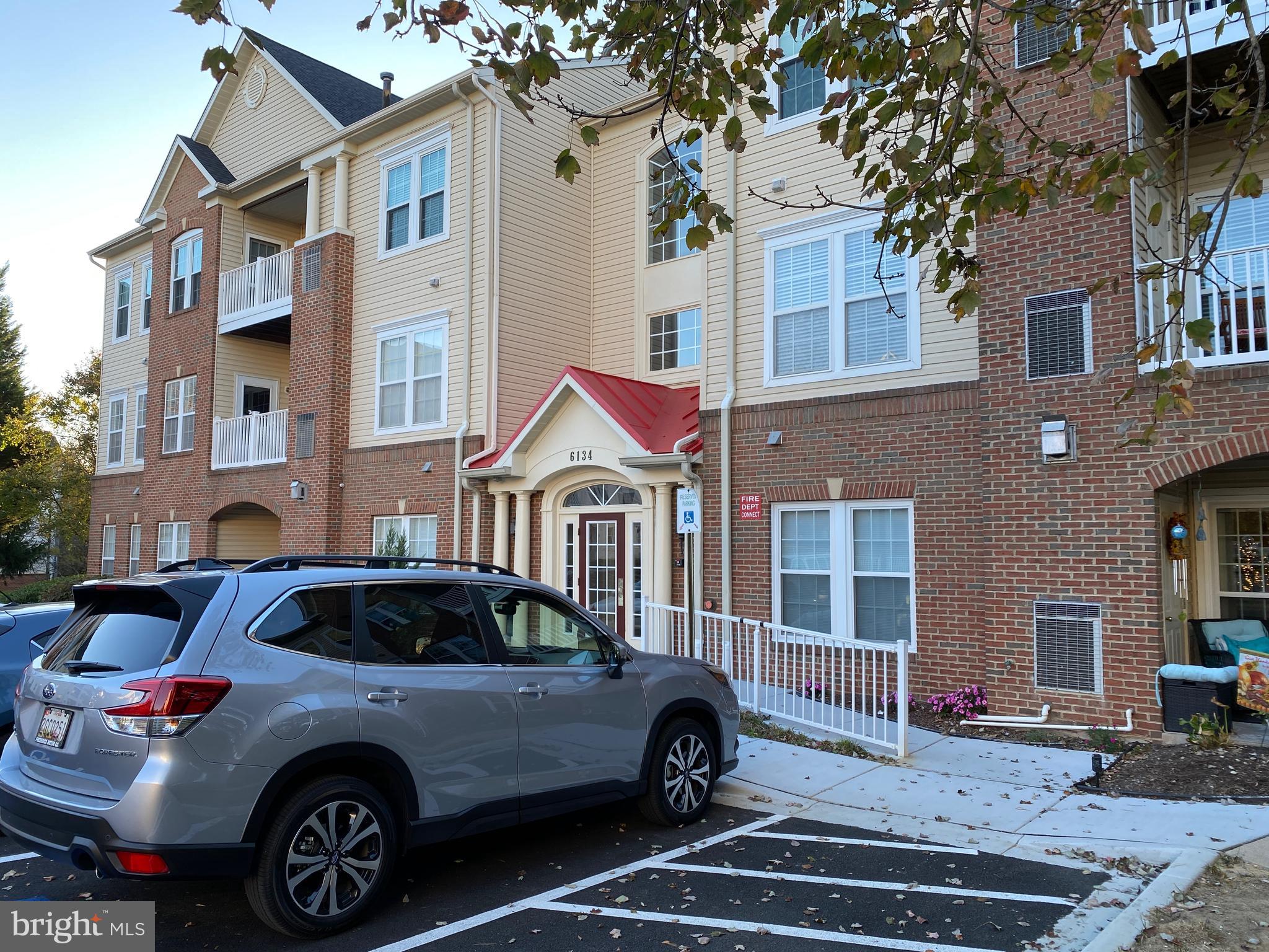 a front view of a house with parking space