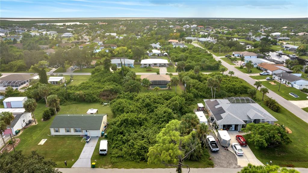 an aerial view of residential houses with city view