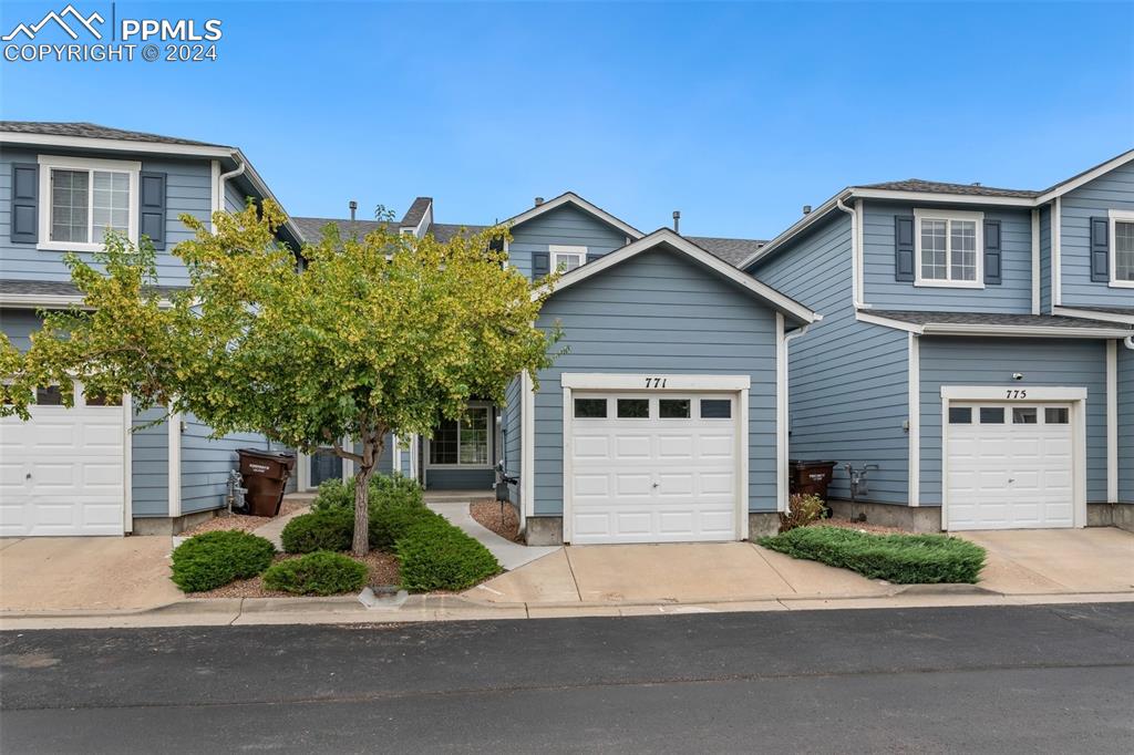 a house that has a tree in front of it