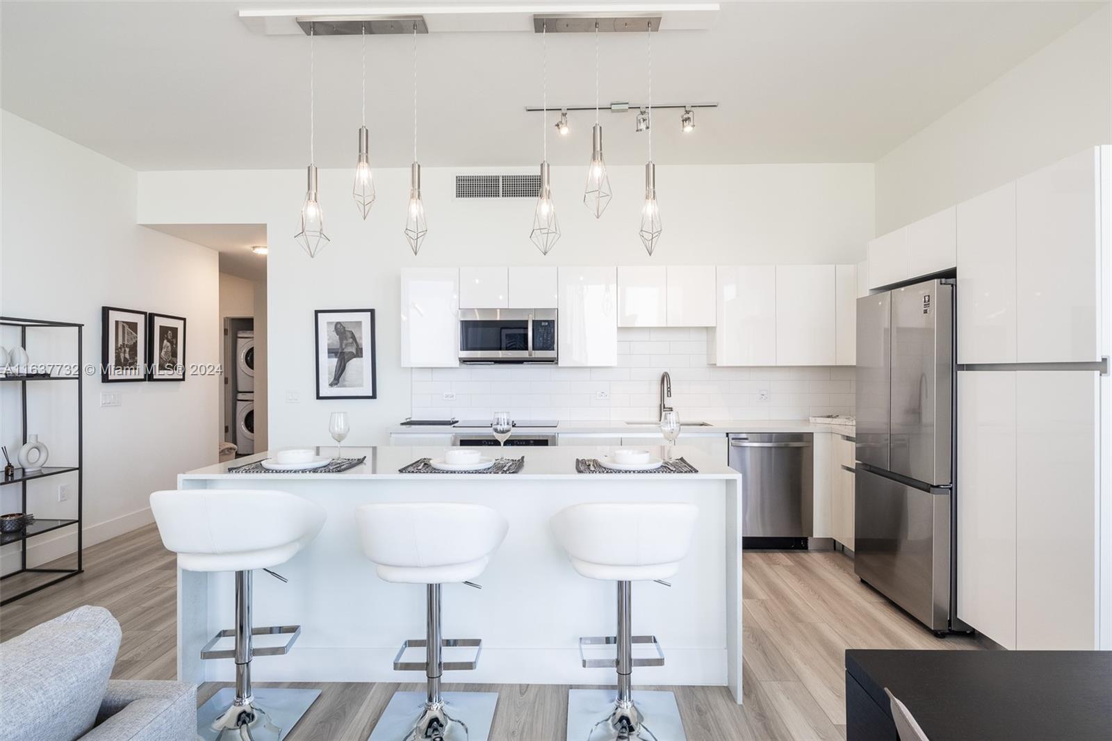 a kitchen with stainless steel appliances a sink cabinets and refrigerator