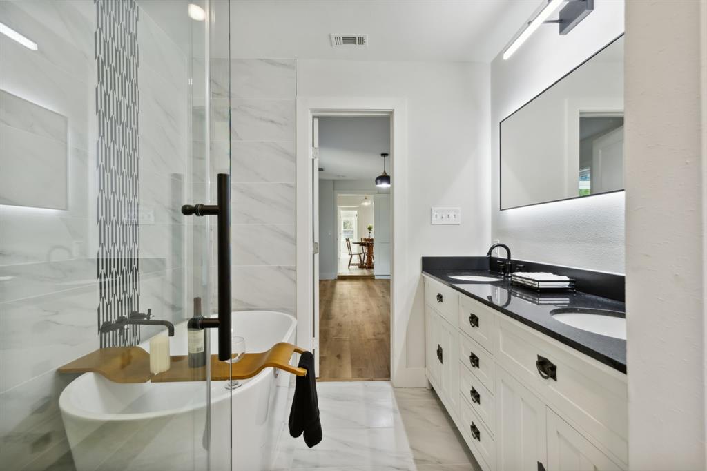 a kitchen with granite countertop a sink stove and refrigerator