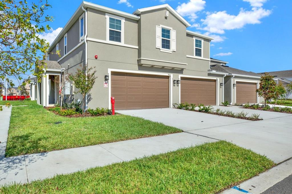 a front view of a house with a yard and garage