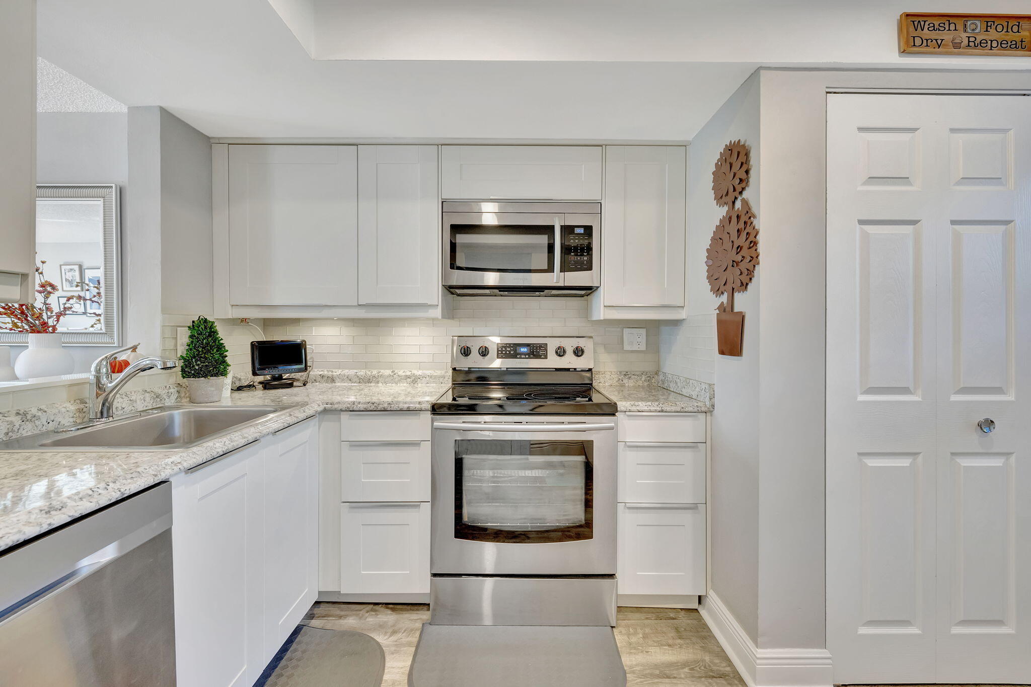 a kitchen with stainless steel appliances granite countertop a stove and a sink