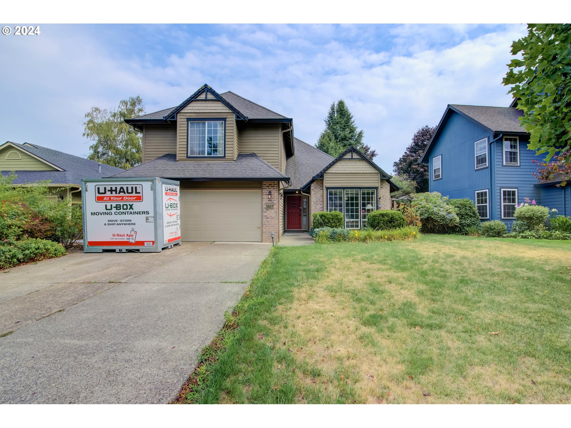 a front view of a house with a yard and garage