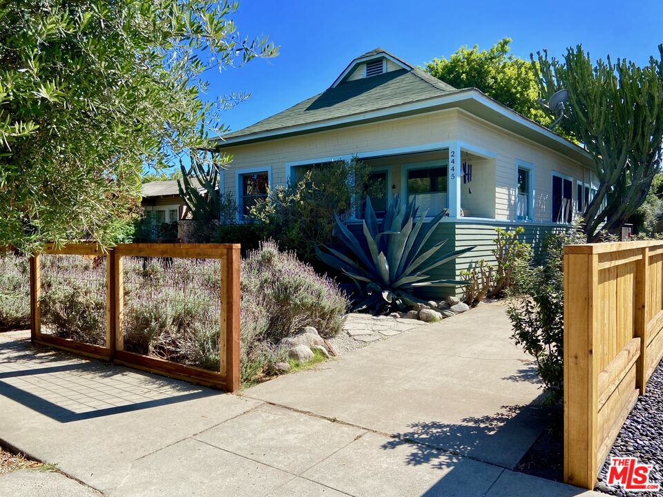 a view of house with wooden fence