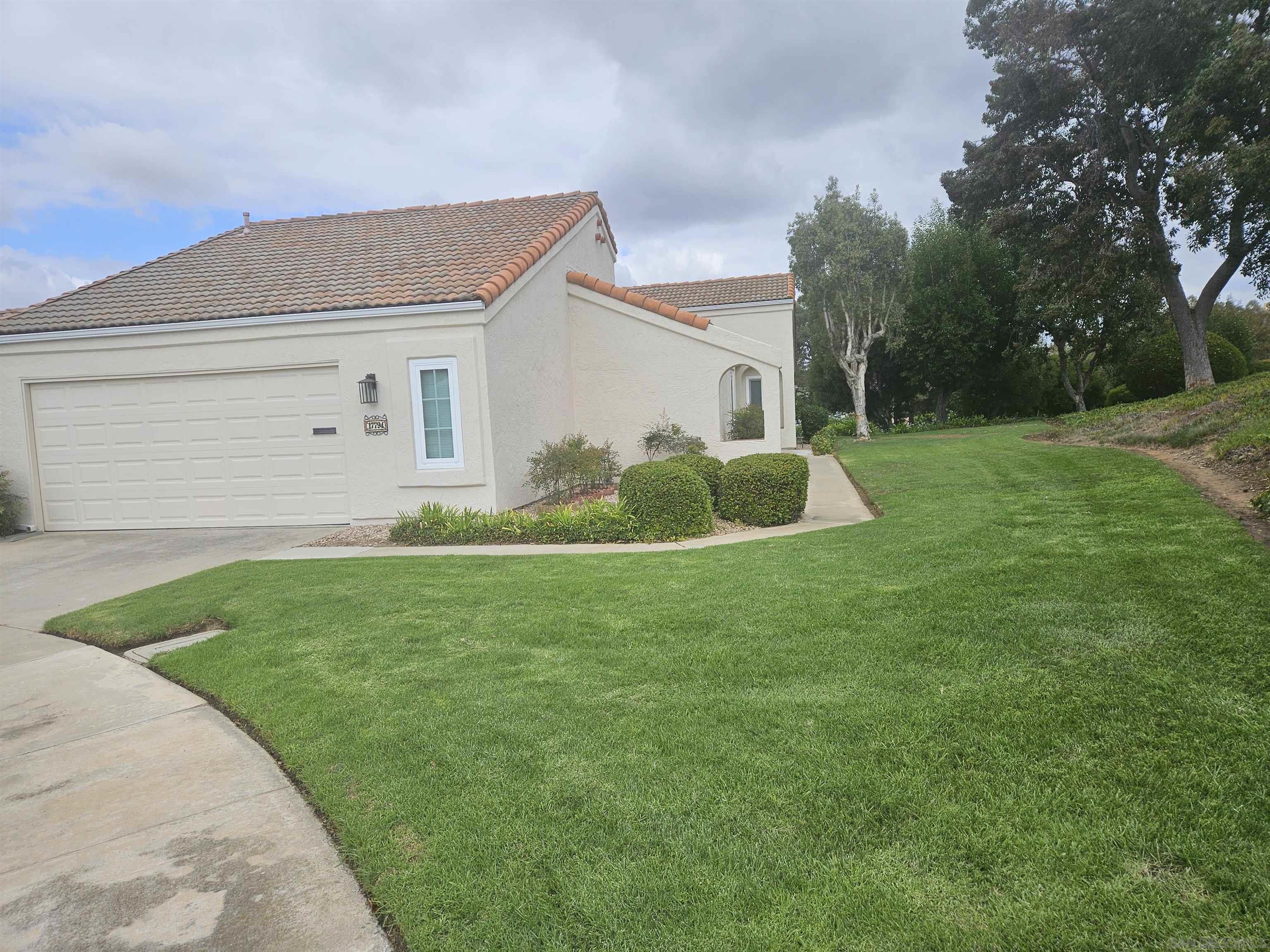 a front view of house with yard and green space