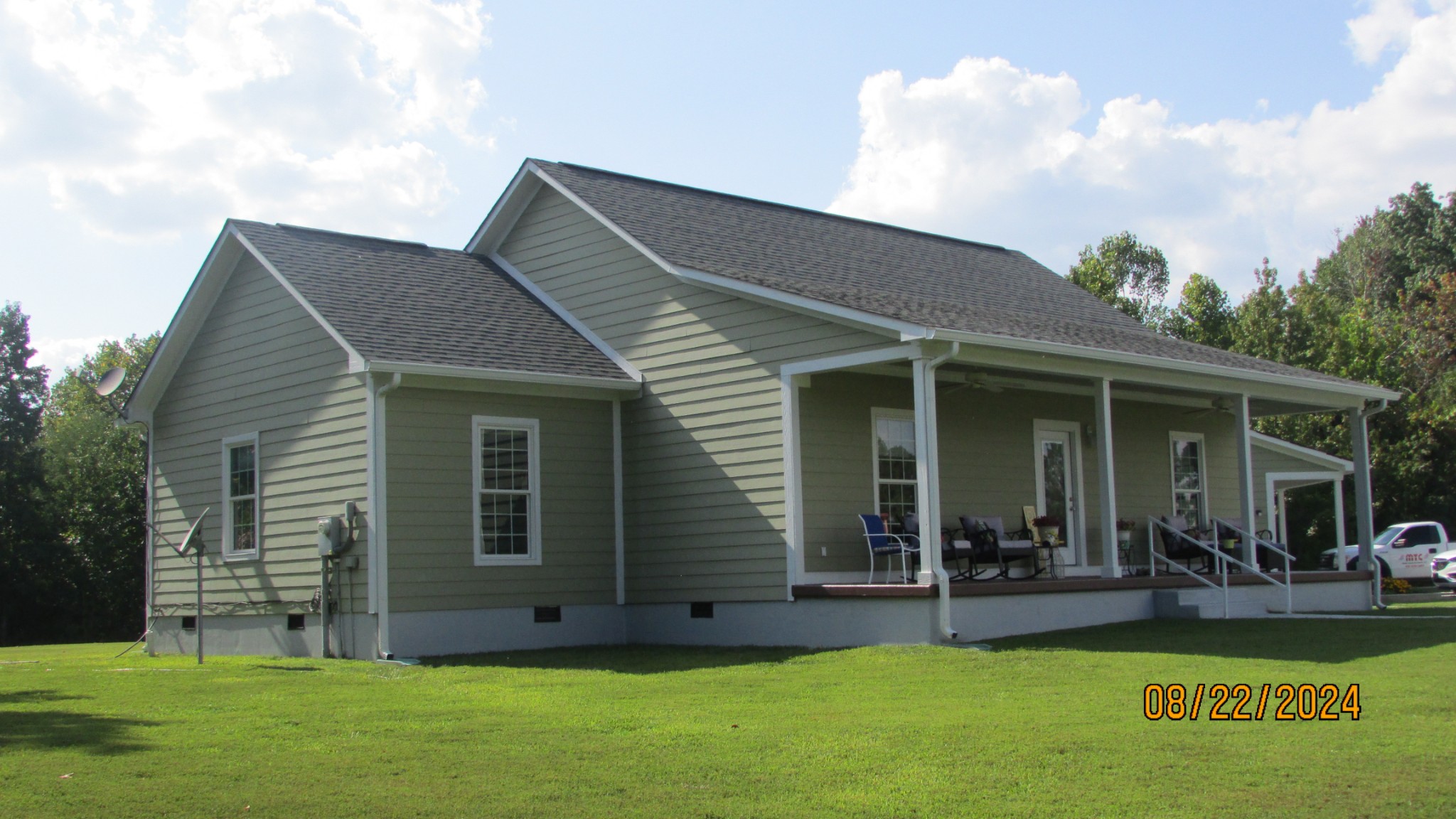 a view of a house with a yard porch and sitting area