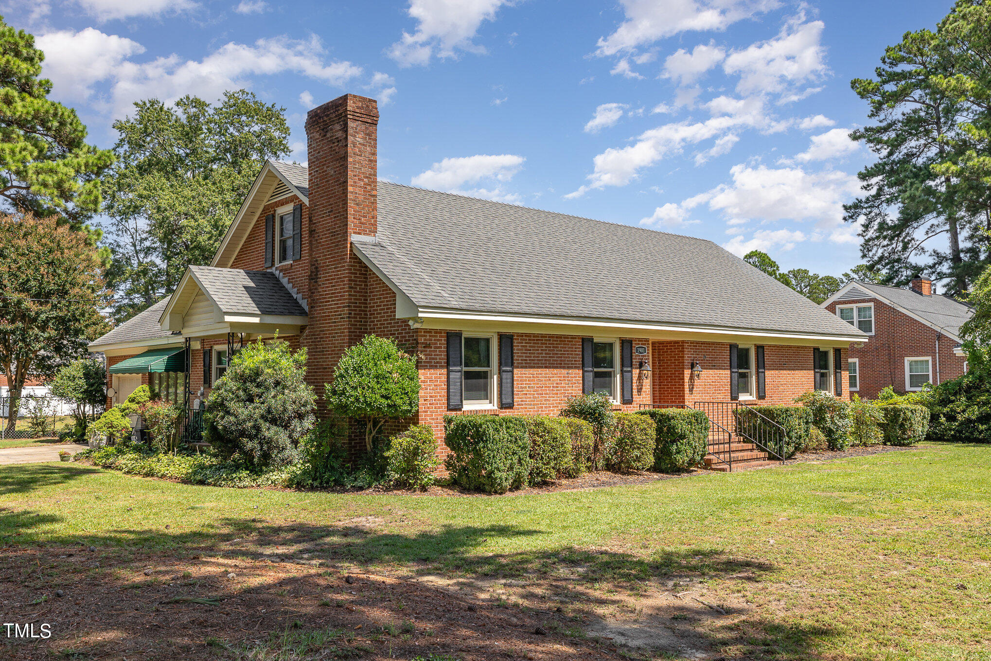 a front view of house with yard and green space