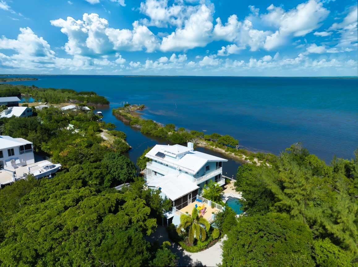 an aerial view of a house with a yard